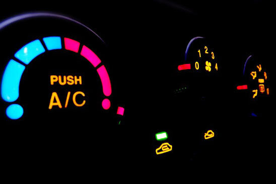 Illuminated car air conditioning controls with the A/C button