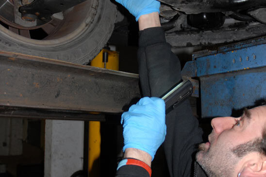 Technician inspecting the underside of a car on the lift at Marsh and Chalfont